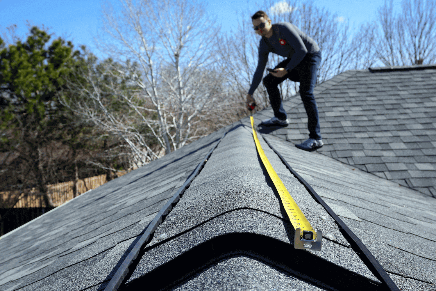 An image depicting a roofing contractor inspecting a roof for legal and warranty considerations.