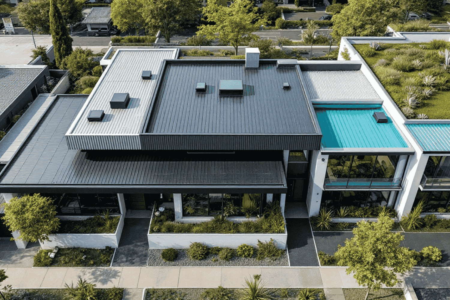 Different types of flat roofing systems displayed on various residential buildings.