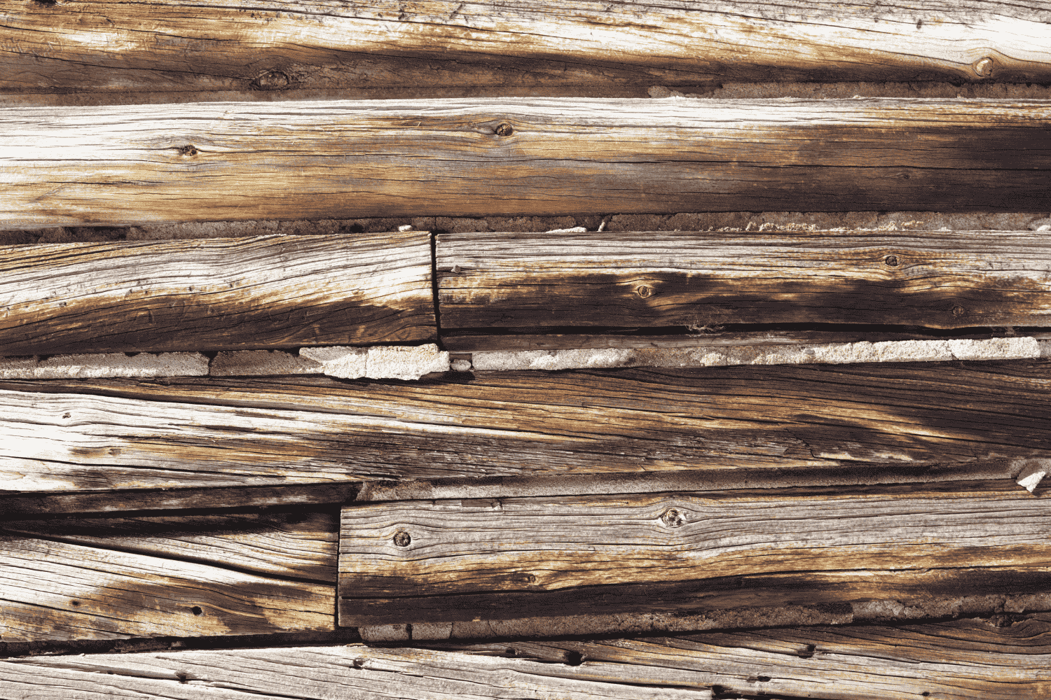 A section of rotted wood siding being examined for repair.